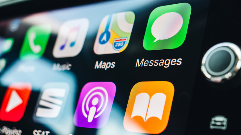 A close-up photograph of Apple CarPlay on a car's infotainment screen.