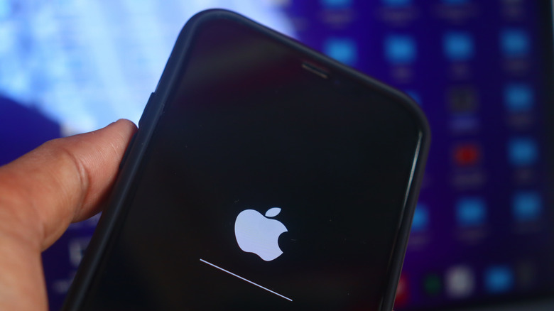 A photograph of a hand holding an iPhone.