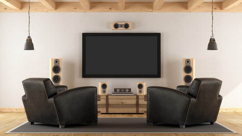 A trendy but rustic living room features a complex surround sound setup