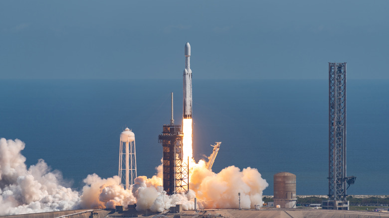 SpaceX Falcon Heavy rocket launching from Earth.