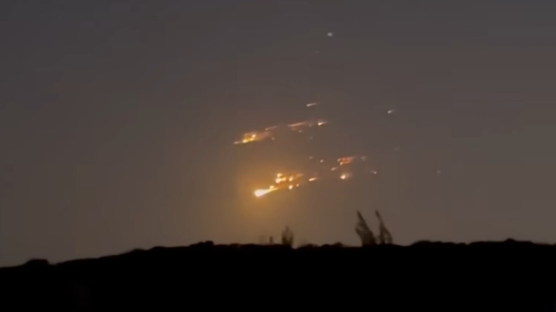 A SpaceX explosion in the night sky.