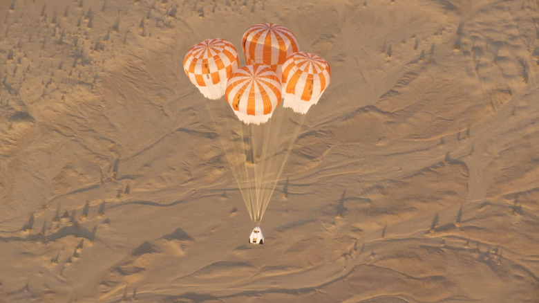 A SpaceX dragon is seen descending as part of a parachute test in 2018