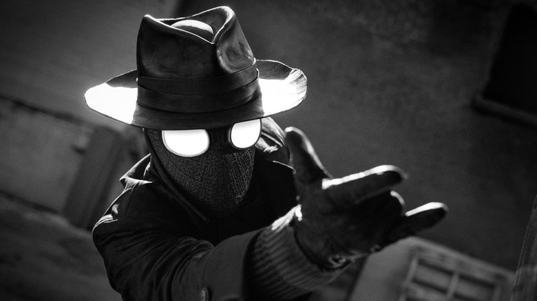 Spider-Noir (Nicolas Cage) getting ready to shoot a web.