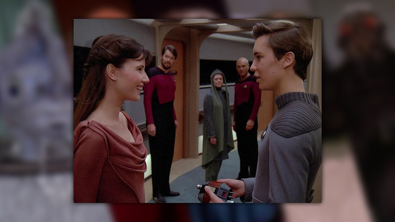 Wesley Crusher flirts with Salia while Riker, Anya and Picard watch