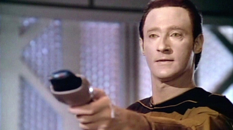 Data wielding a phaser weapon on the show Star Trek The Next Generation