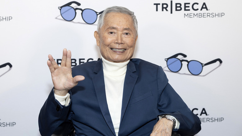 George Takei holding up the Vulcan salute