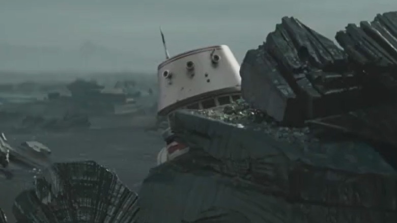 R5-D4 astromech droid hiding behind rocks in The Mandalorian