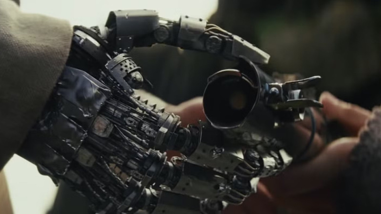 Screenshot of Luke's fake hand holding a lightsaber from 