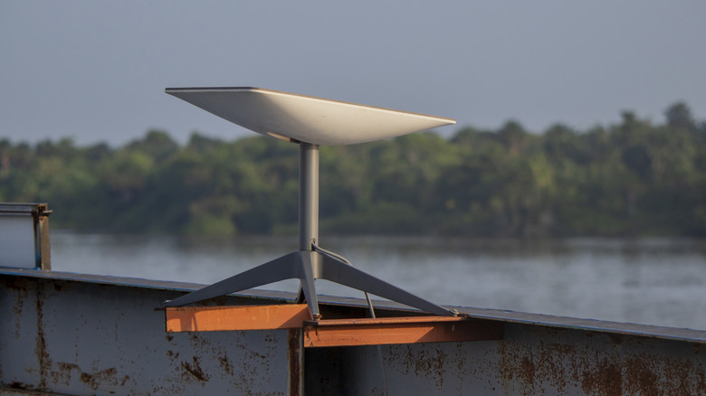 A Starlink receiver mounted to a beam in an outdoor setting.