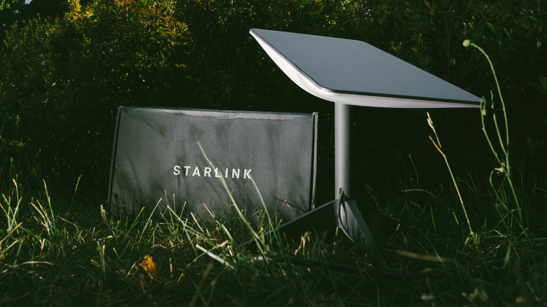 A Starlink dish set up in the grass.