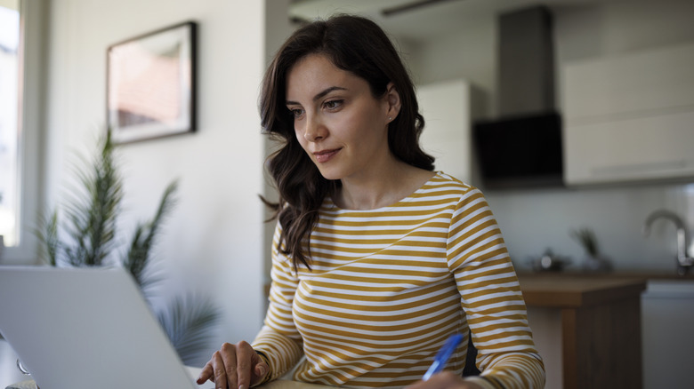 Woman using the internet on her laptop