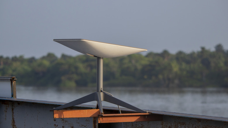 a Starlink satellite mounted outside near a river