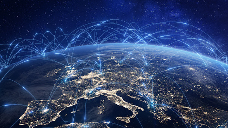 Visual representation of an interconnected Earth with blue beams of light all over