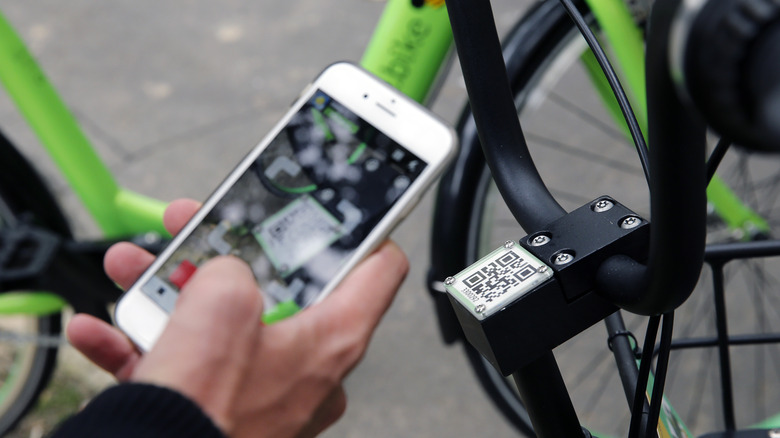 Person scanning QR code for a bicycle rental