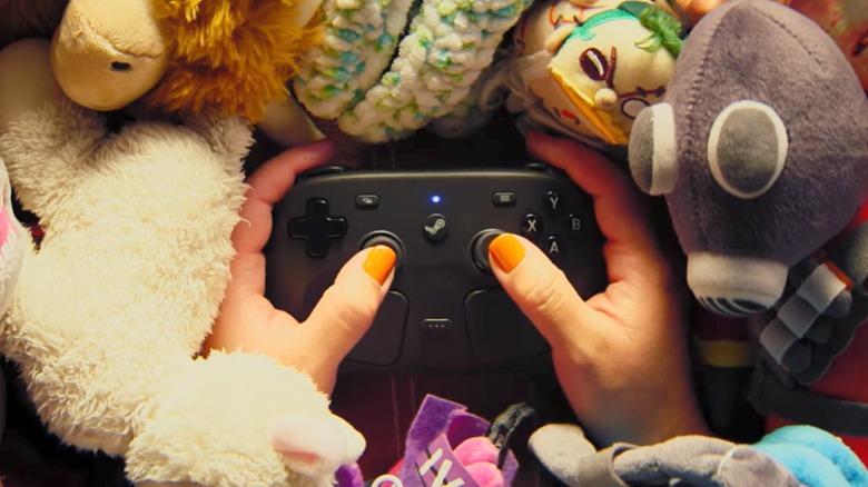 Person holding a Steam Controller surrounded by plushies
