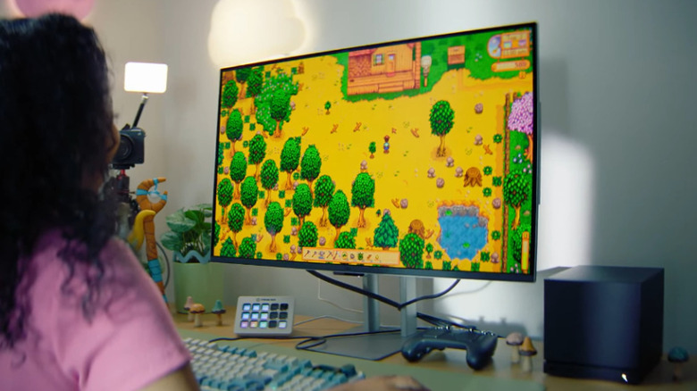 A person playing a PC game using the Steam Machine