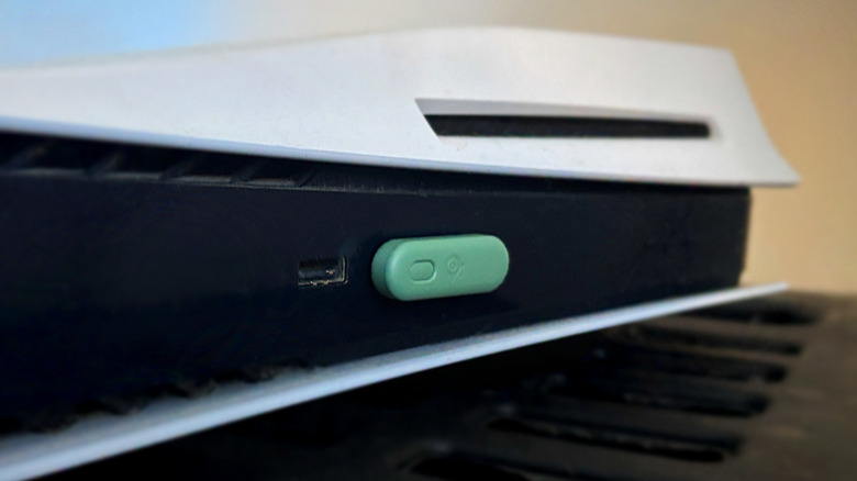Green USB-C dongle connected to front PS5 USB port.
