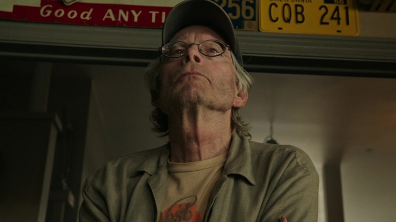 Stephen King's unnamed store owner looking at something in 