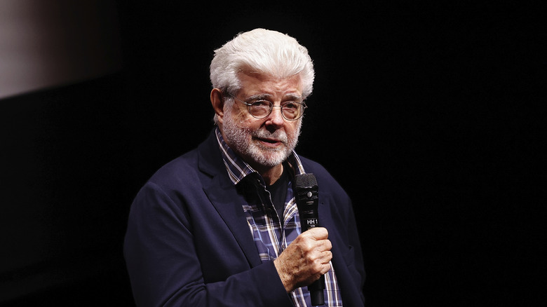 George Lucas holding a microphone