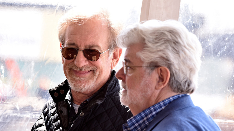 Steven Spielberg looking at George Lucas, who is in profile looking at something out of frame