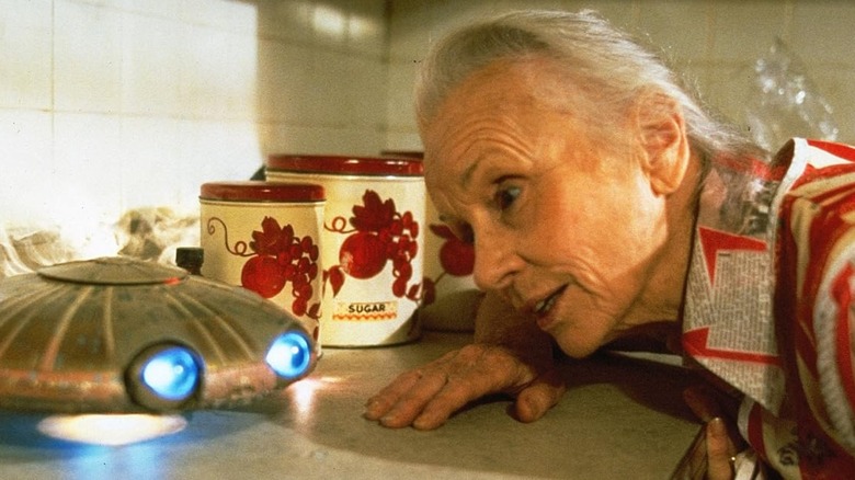 Faye (Jessica Tandy) looking at a flying saucer in a kitchen in Batteries Not Included
