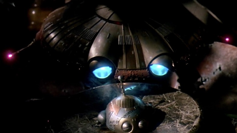 A sad flying saucer looking at a baby flying saucer in Batteries Not Included