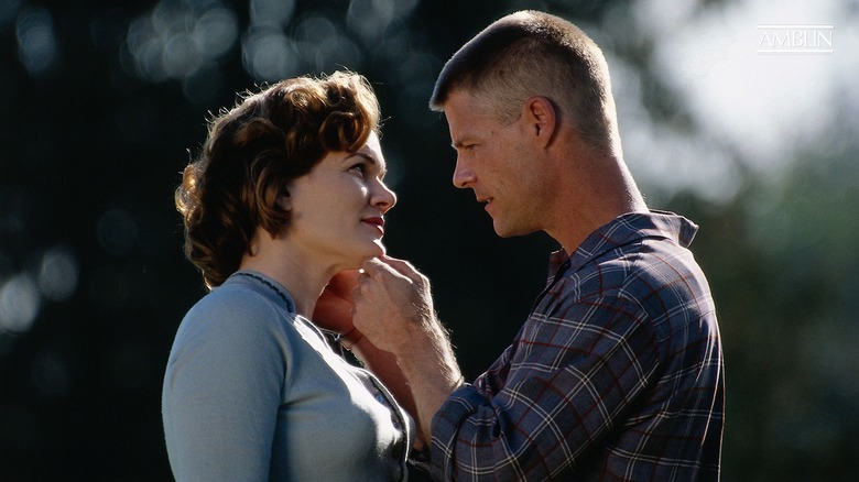 A screenshot from the 2002 miniseries "Taken." The image shows actor Joel Gretsch with his hands on the face of actress Heather Donahue, the two seemingly sharing a compassionate moment.