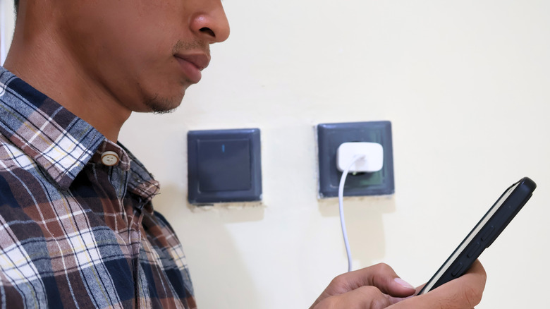 A man using a phone while its charging