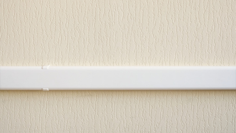 white cable raceway attached to a wall to run ethernet cables
