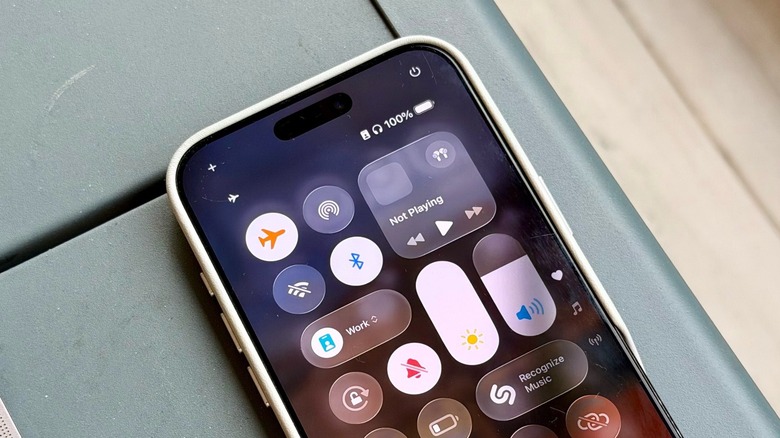 An iPhone on a table with the Control Center being displayed
