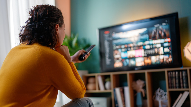 a woman watching TV at home