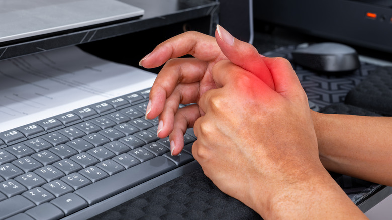 Close up of person's hand with redness indicating pain from using keyboard
