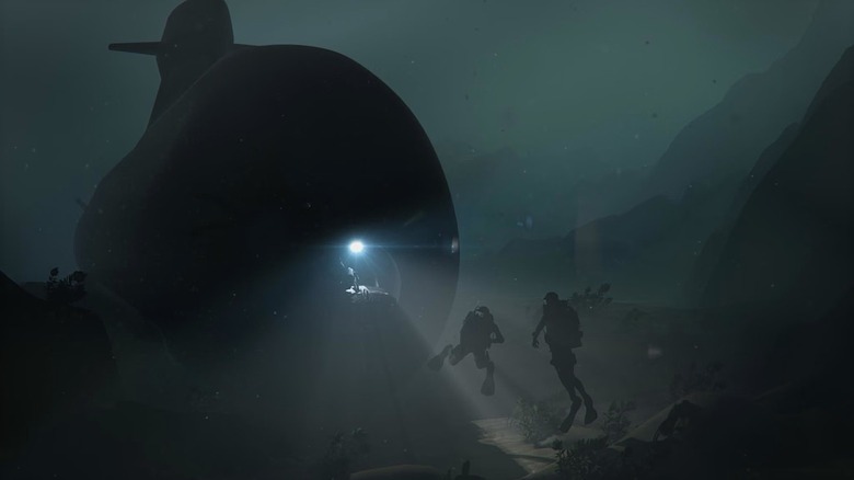 Saab Blekinge-class (A26) submarine with lights on and divers nearby