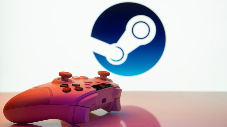 a gaming controller on a desk with the Steam logo in the background