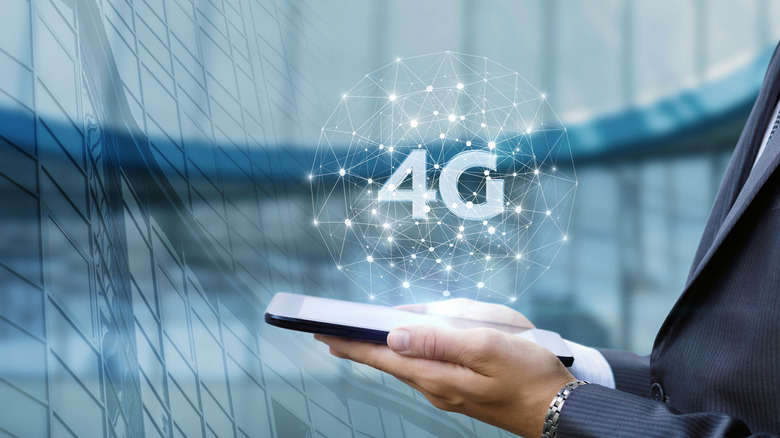 Person holding a smartphone with concept icon of 4G hovering over it