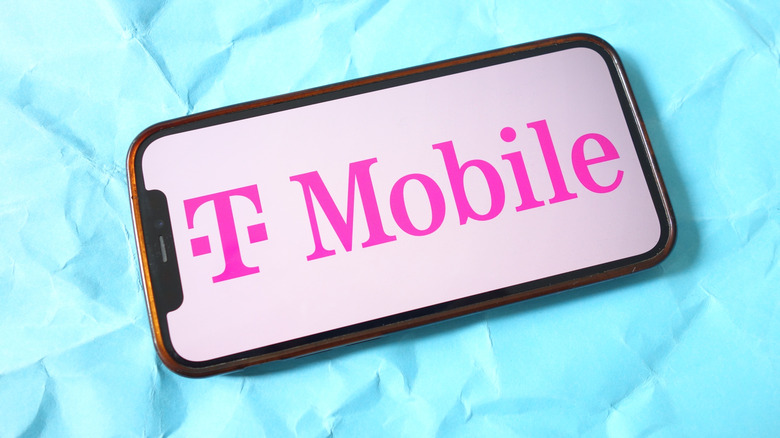 smartphone with t-mobile logo on it, on blue background