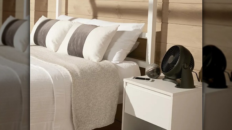 Desk fan placed on a bedside table
