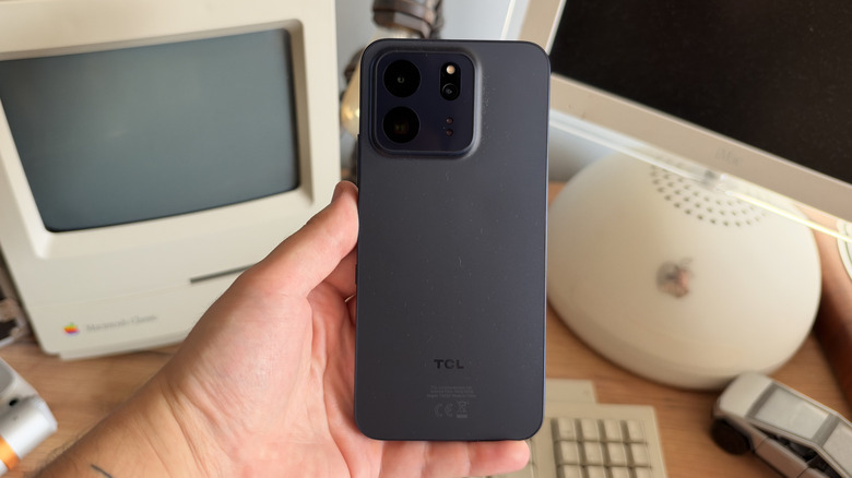 TCL P80 Ultra being held in one hand with the rear panel facing the camera