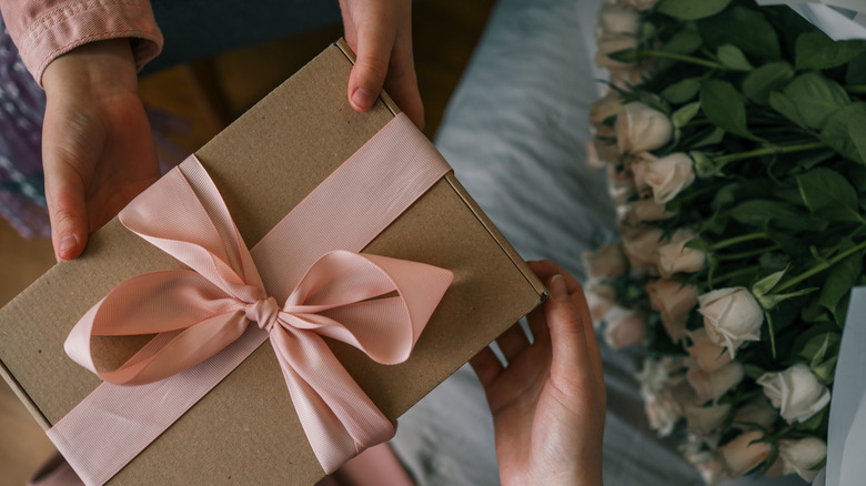 a gift box with flowers in the backdrop