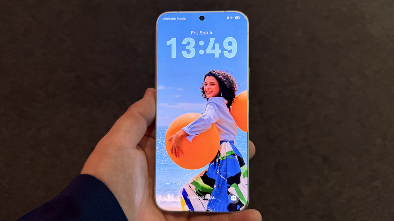 Holding the Tecno bezel-less phone in hand