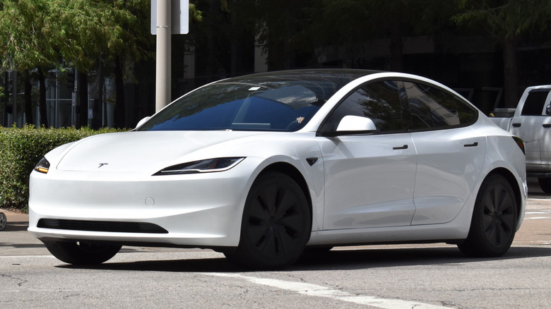 Tesla vehicle driving on the lot