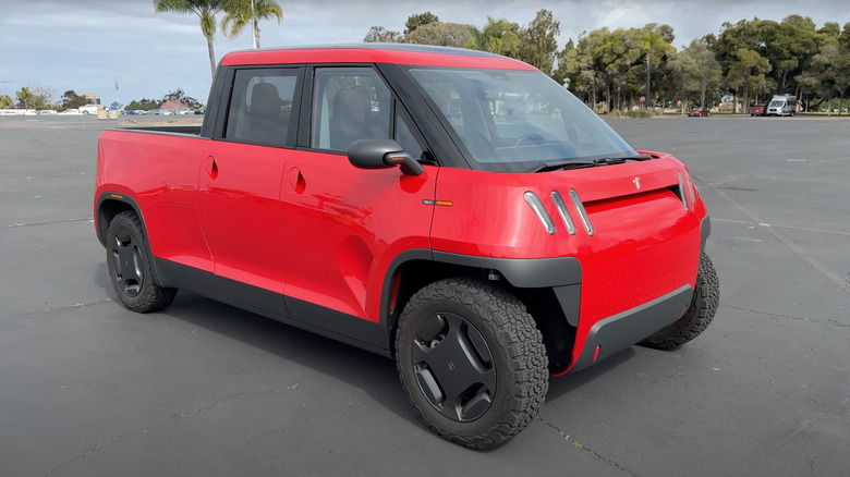 A red TELO MT-1 in a parking lot, front 3/4 view