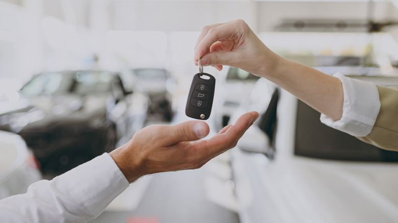 a person at a car dealership buying a new vehicle