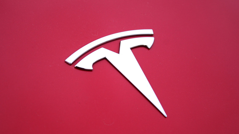 the Tesla logo on a red car