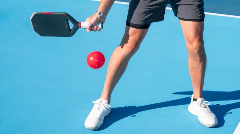 Player using the Tesla pickleball paddle to hit the ball.