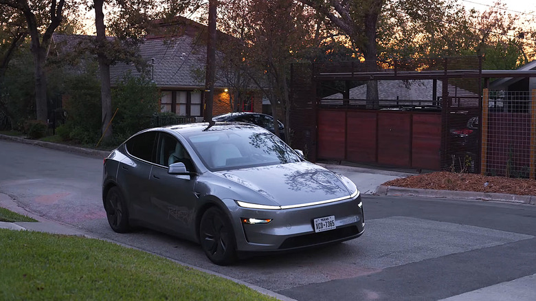 A Tesla Robotaxi dropping off a passenger at their destination.