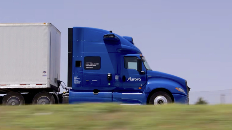 An Aurora Innovation autonomous truck driving along a highway.
