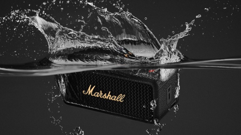 a Marshall Emberton III speaker being dunked in water