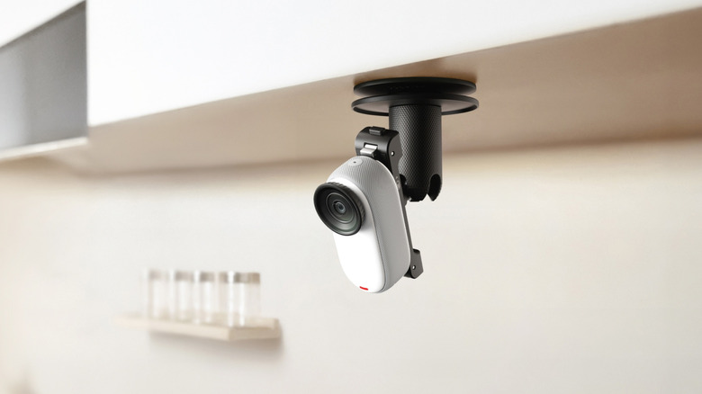 An Insta360 Go 3s camera mounted underneath a camera