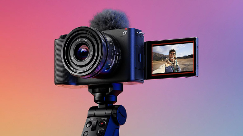 A Sony ZV-E1 camera mounted on a tripod with the screen flipped to face the subect